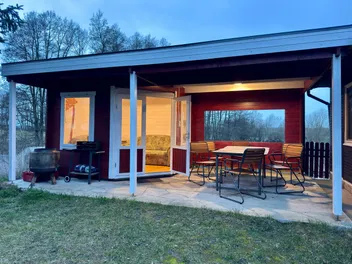 Holiday home with covered terrace at dusk